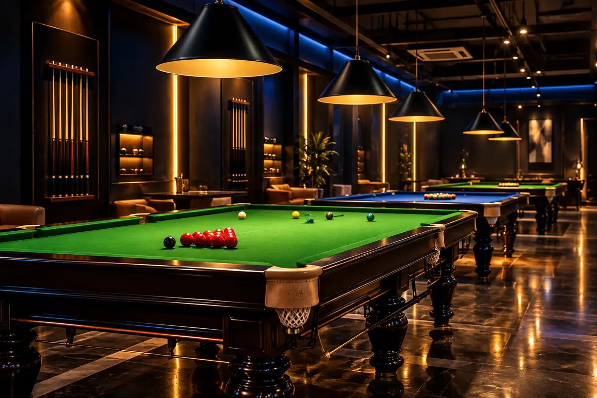Snooker tables under spotlights in an indoor sports club